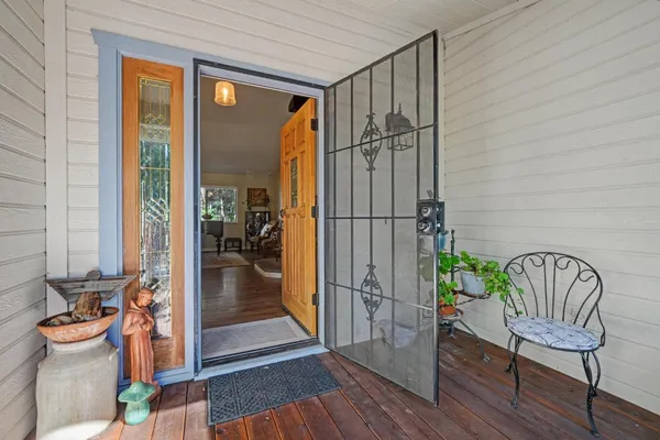 a view of a hallway with dining room and wooden floor