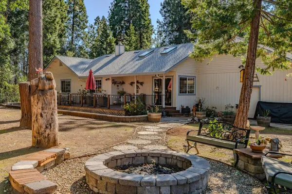 a view of a house with backyard outdoor seating area and furniture