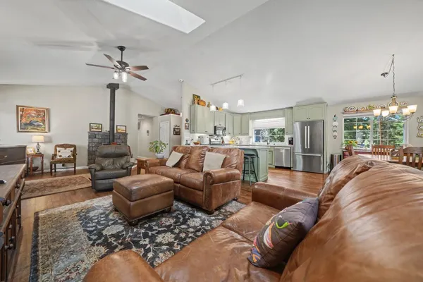 a living room with furniture a fireplace and a chandelier