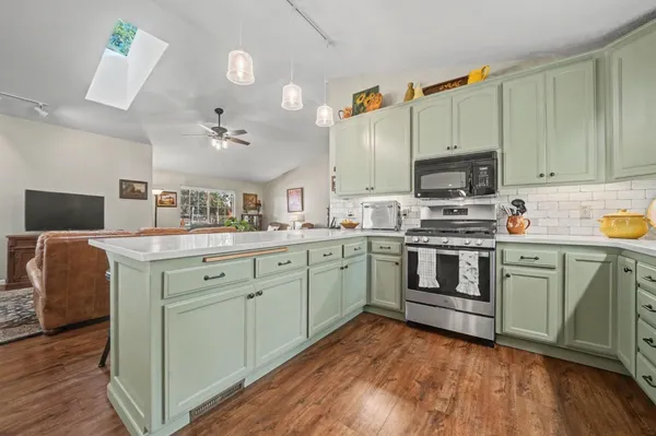 a kitchen with a sink cabinets and stainless steel appliances