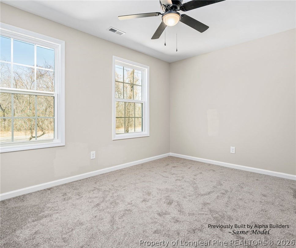 973 Martin Road St. Pauls, NC 28384 - Photo 12 of 19 Spacious upstairs guest bedroom with ceiling fan and natural light.