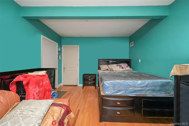 a bedroom with two beds and a potted plant