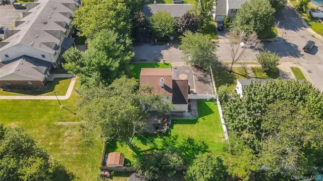 an aerial view of a house with a yard swimming pool and outdoor seating