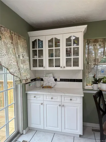 a view of a kitchen with granite countertop cabinets and windows