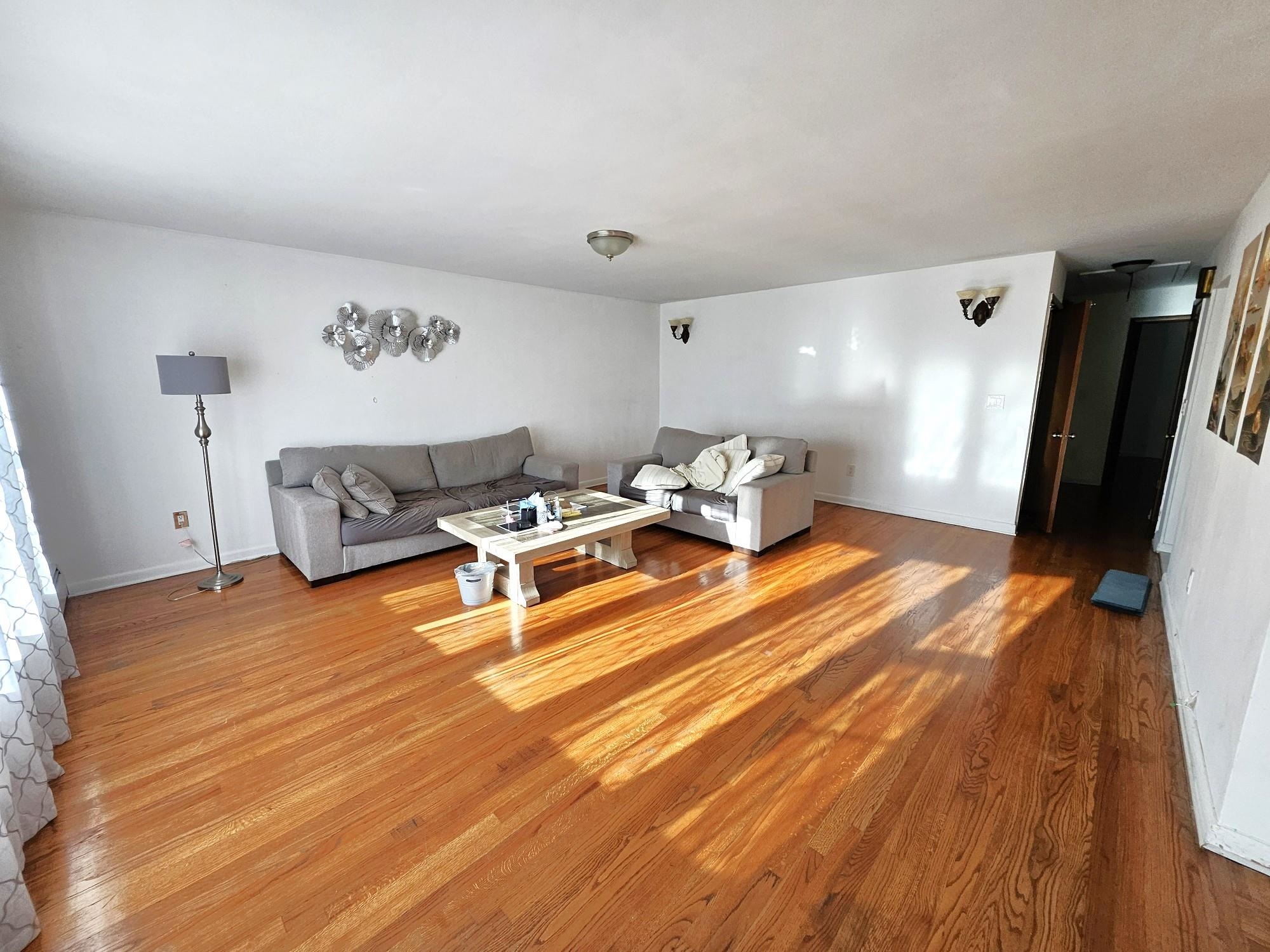 775 3rd Street, Unit 2 Secaucus, NJ 07094 - Photo 2 of 23 a living room with furniture and a wooden floor