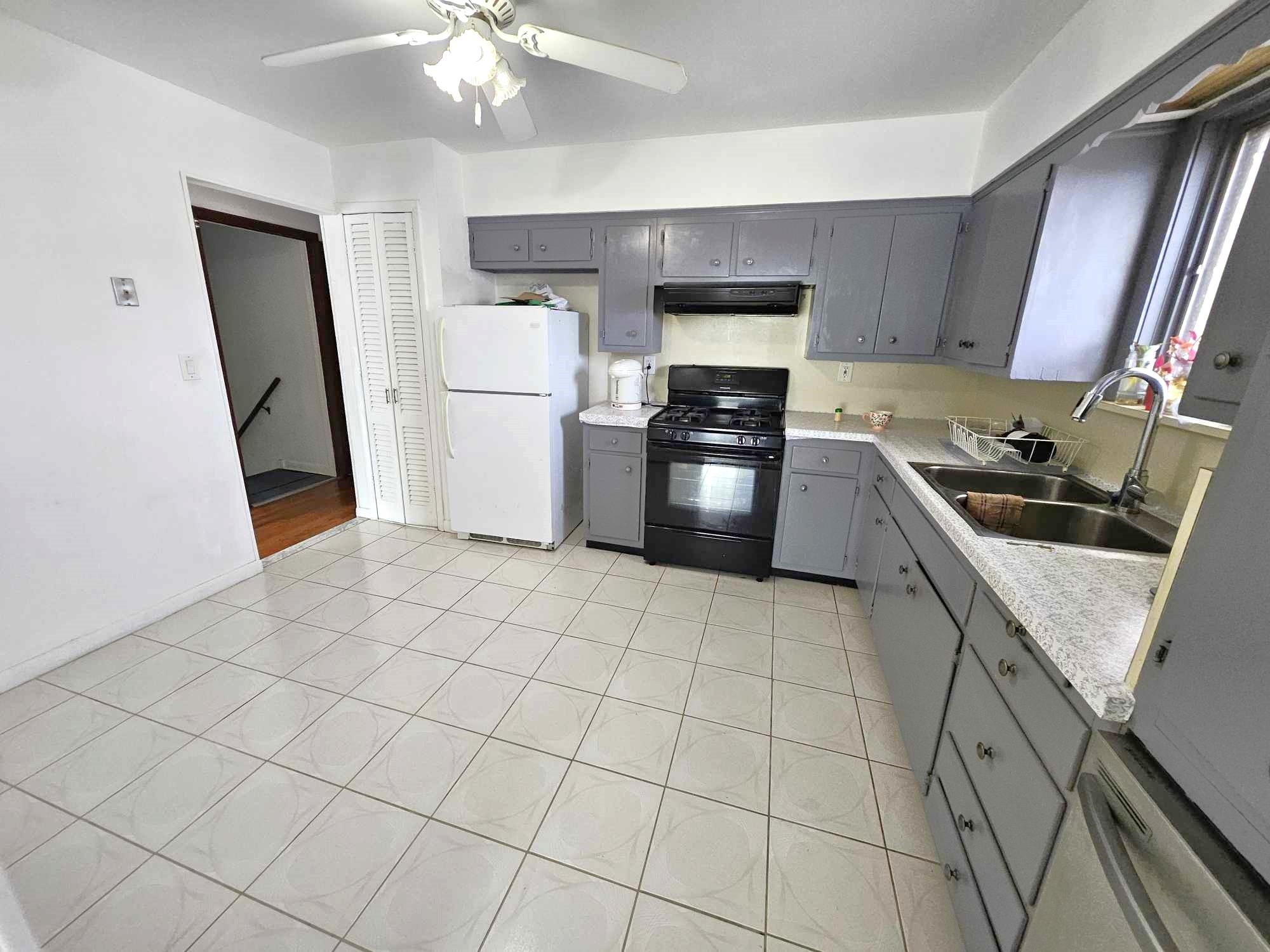 775 3rd Street, Unit 2 Secaucus, NJ 07094 - Photo 5 of 23 a kitchen with granite countertop a stove a sink and a refrigerator