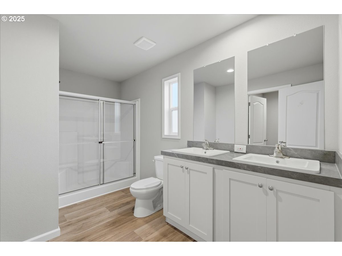 20815 Walnut Street Northeast Aurora, OR 97002 - Photo 23 of 32 a bathroom with a granite countertop sink a toilet and a mirror