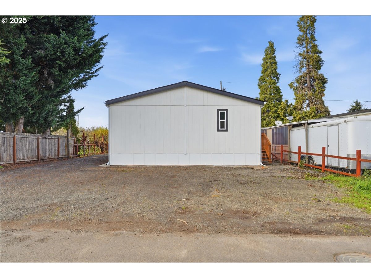 20815 Walnut Street Northeast Aurora, OR 97002 - Photo 27 of 32 a view of a house with a yard and garage