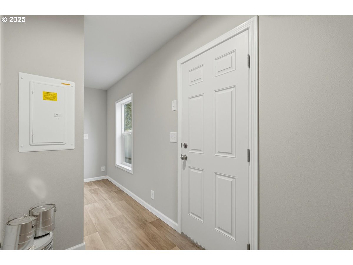 20815 Walnut Street Northeast Aurora, OR 97002 - Photo 5 of 32 a view of a hallway with wooden floor