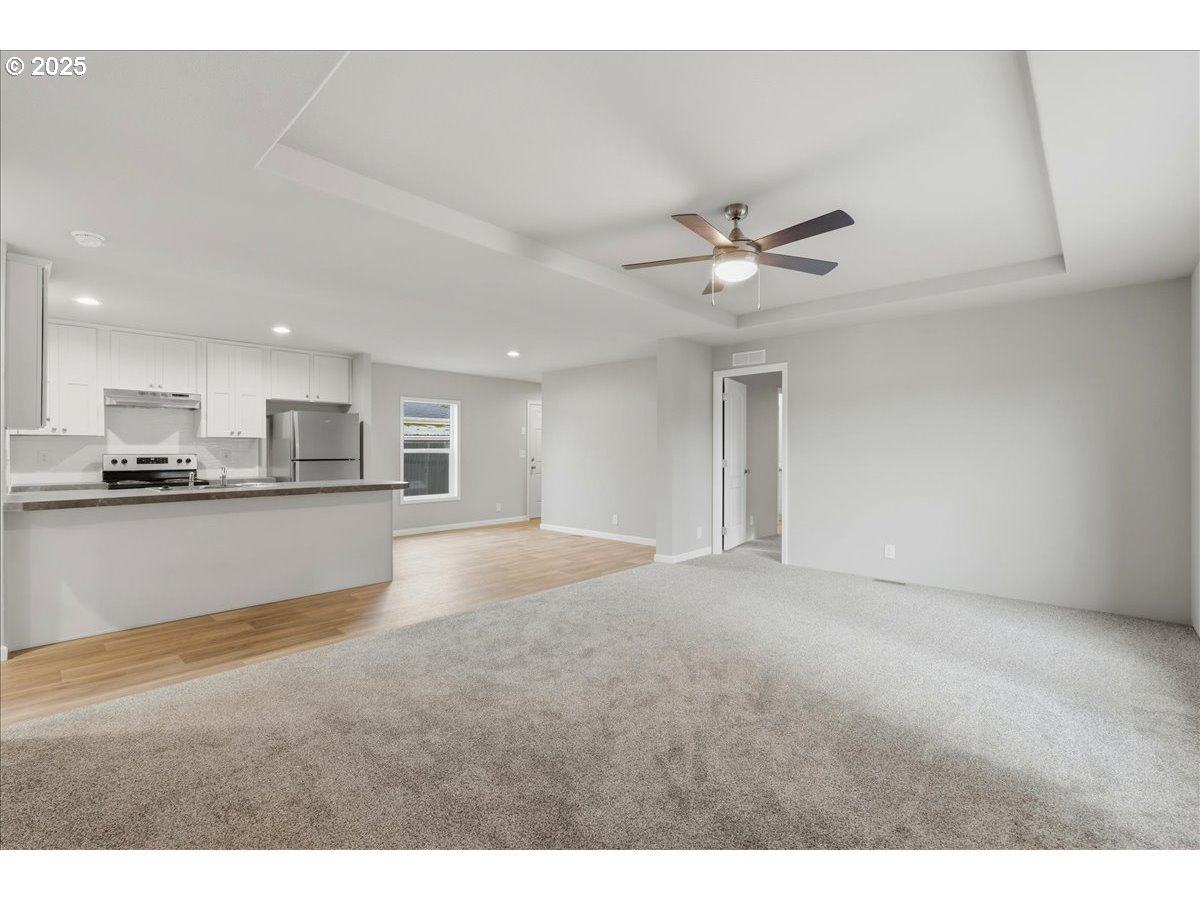 20815 Walnut Street Northeast Aurora, OR 97002 - Photo 6 of 32 a view of an empty room with a kitchen