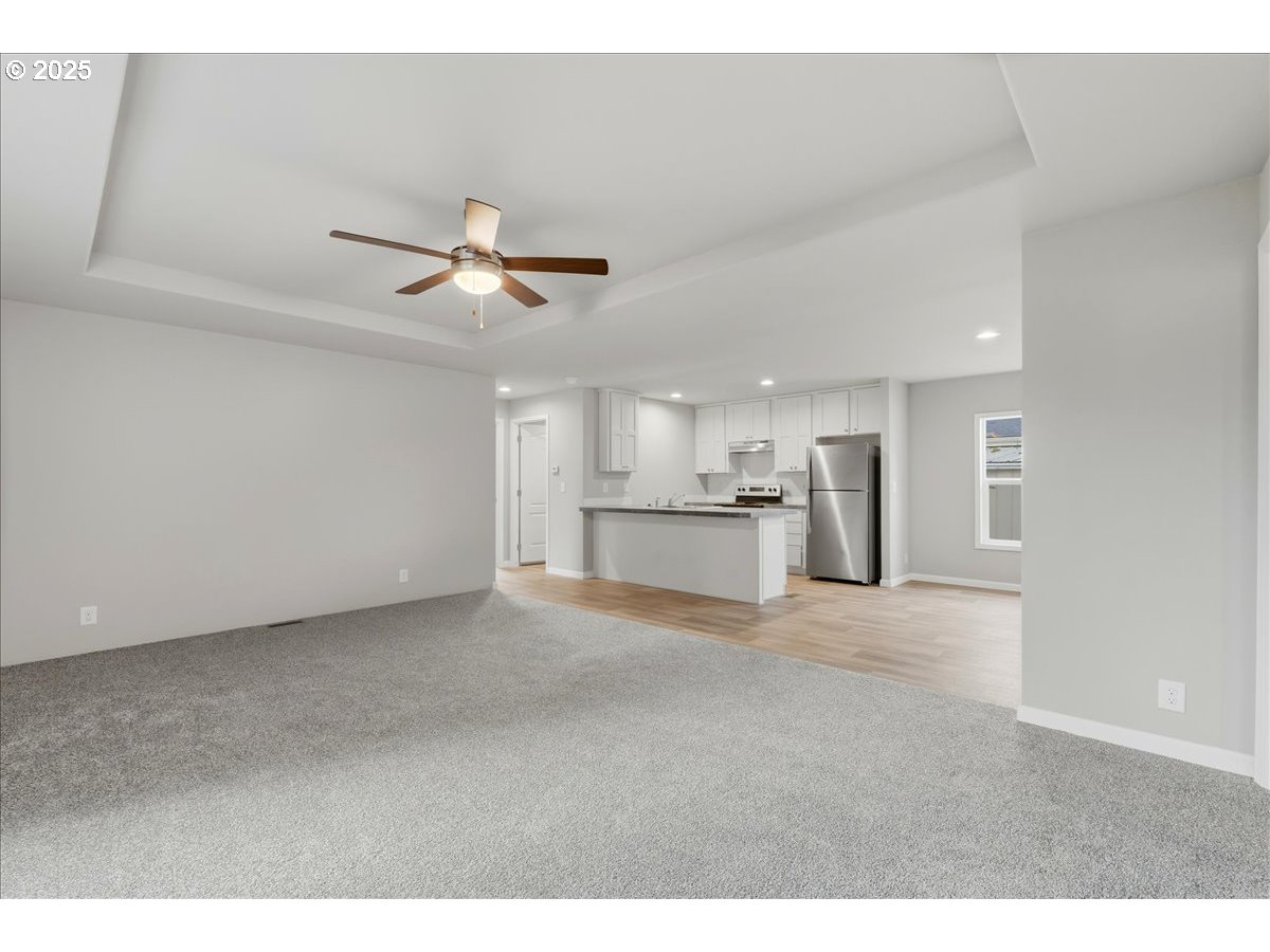 20815 Walnut Street Northeast Aurora, OR 97002 - Photo 7 of 32 a view of a kitchen with a sink and a refrigerator