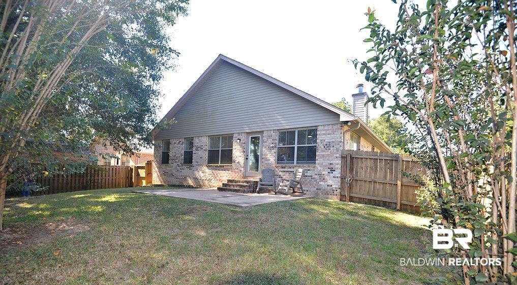 11201 Herschel Loop Daphne, AL 36526 - Photo 27 of 32 Back of house with a patio area and a yard