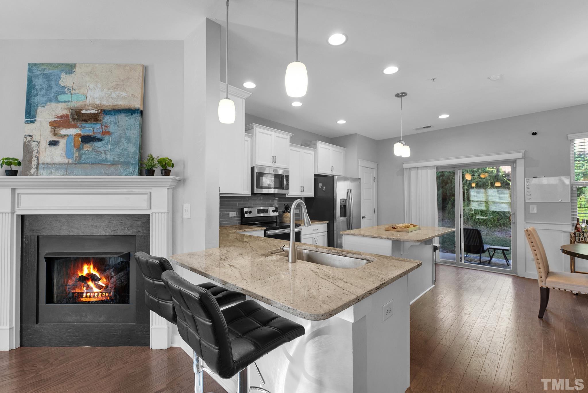7810 Allscott Way Raleigh, NC 27612 - Photo 14 of 29 a kitchen with sink refrigerator and microwave