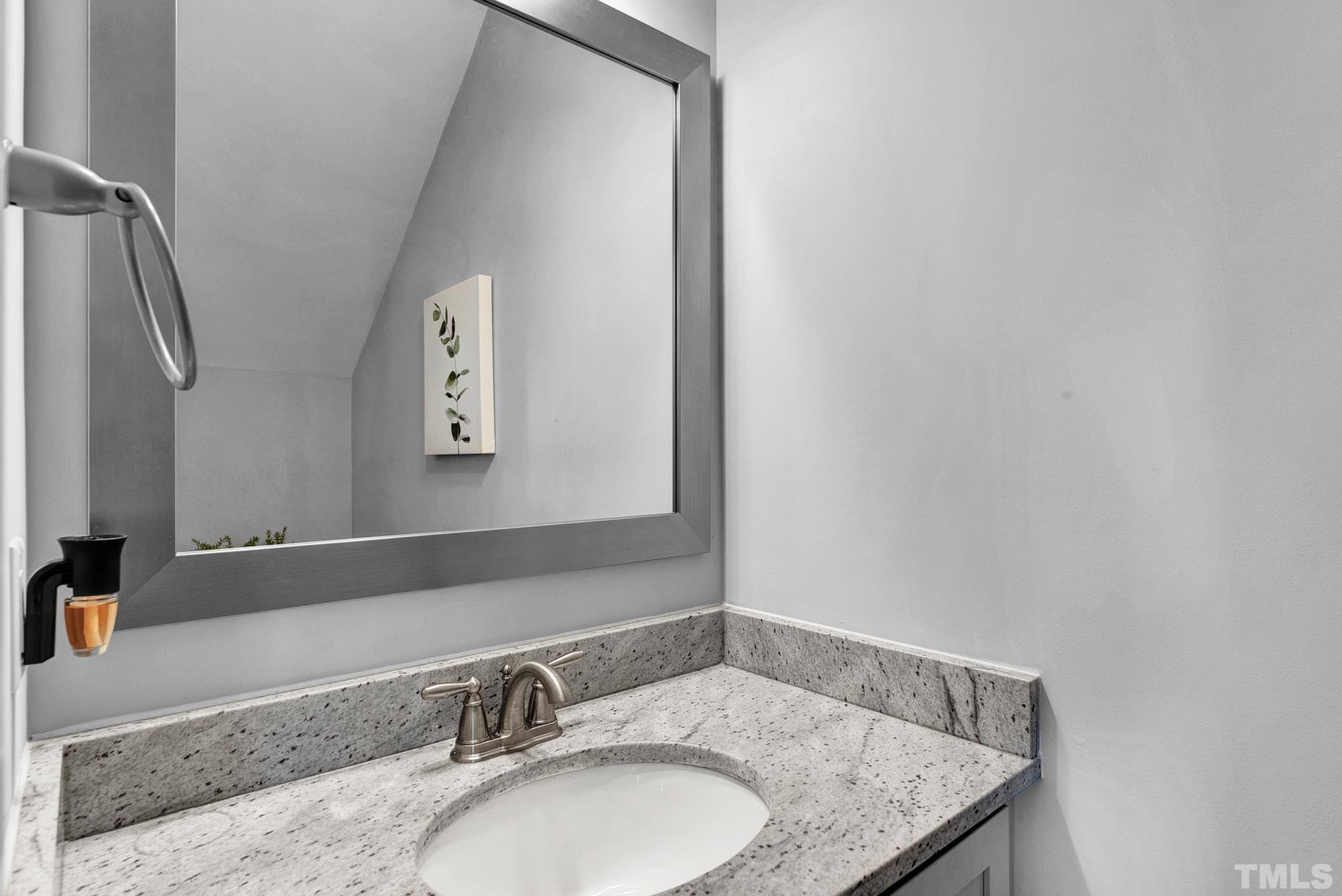 7810 Allscott Way Raleigh, NC 27612 - Photo 21 of 29 a bathroom with a granite countertop sink and a mirror