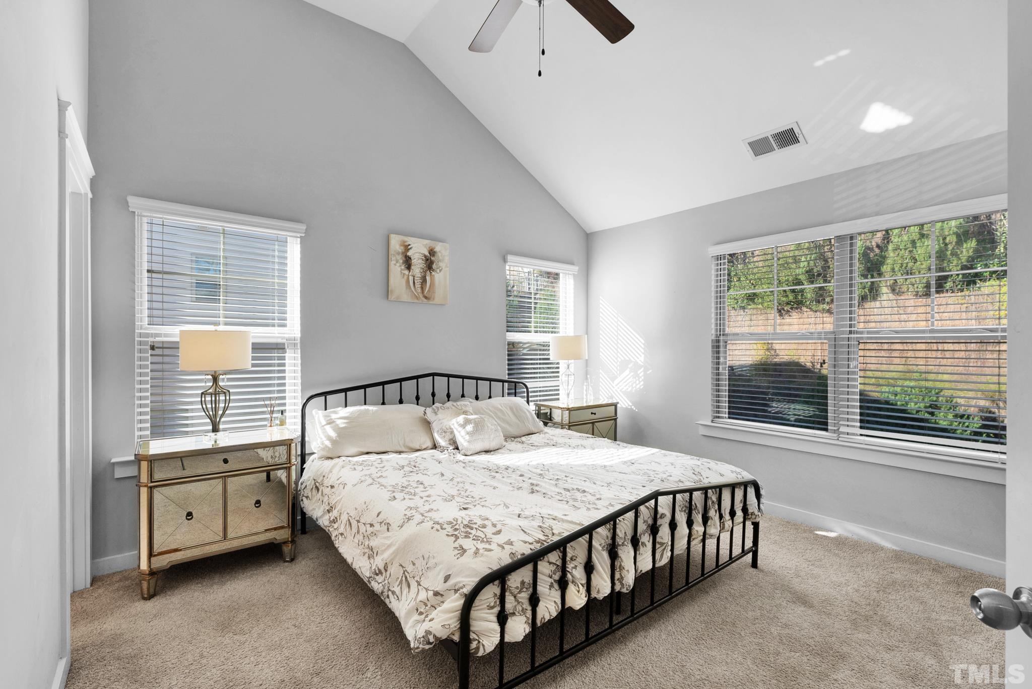 7810 Allscott Way Raleigh, NC 27612 - Photo 22 of 29 a bedroom with a large bed and a large window
