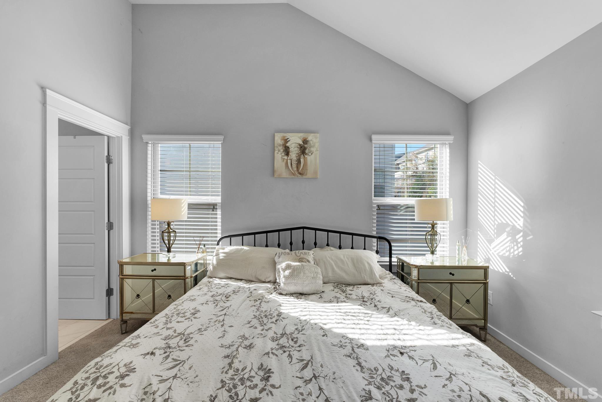 7810 Allscott Way Raleigh, NC 27612 - Photo 23 of 29 a bedroom with a bed and wooden floor