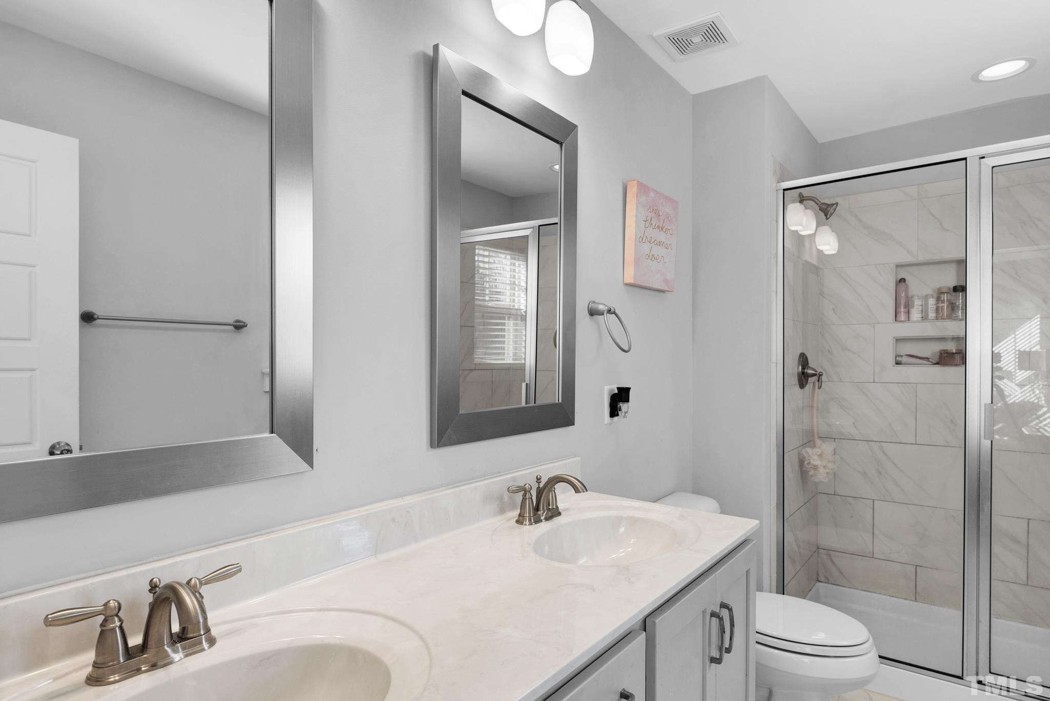 7810 Allscott Way Raleigh, NC 27612 - Photo 26 of 29 a bathroom with a sink vanity granite toilet and shower