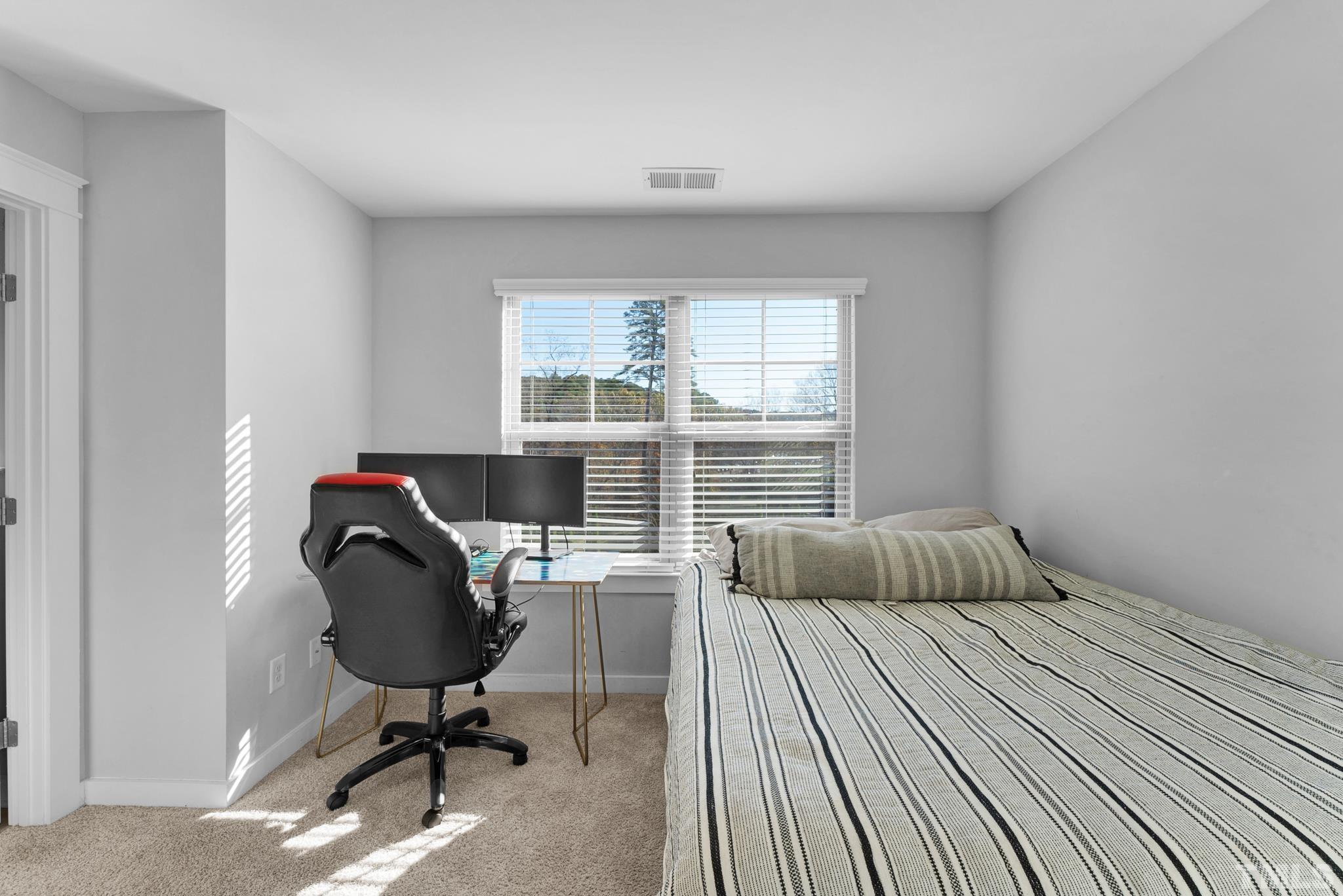 7810 Allscott Way Raleigh, NC 27612 - Photo 28 of 29 a bedroom with a bed and a window