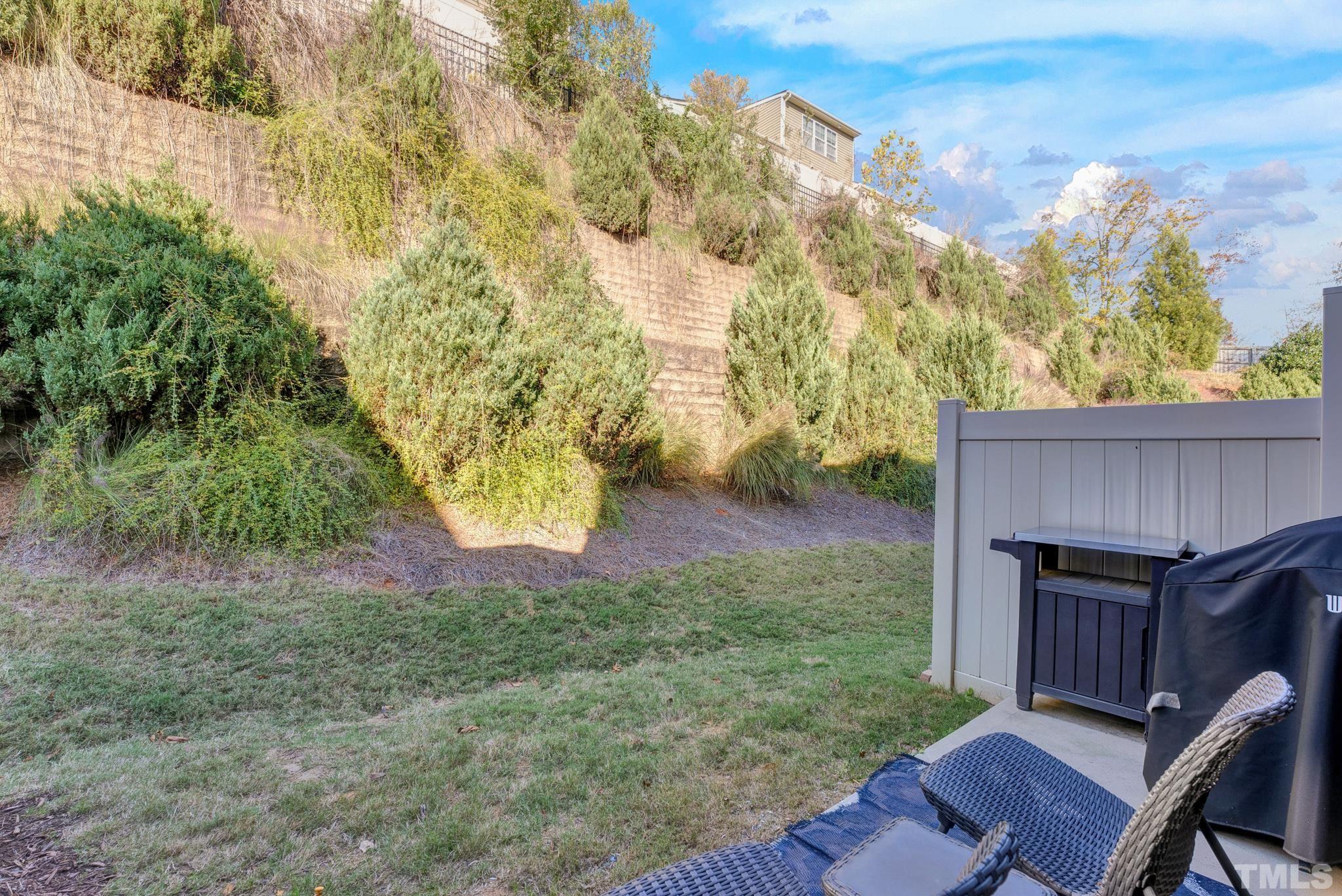 7810 Allscott Way Raleigh, NC 27612 - Photo 7 of 29 a view of backyard with wooden fence and trees