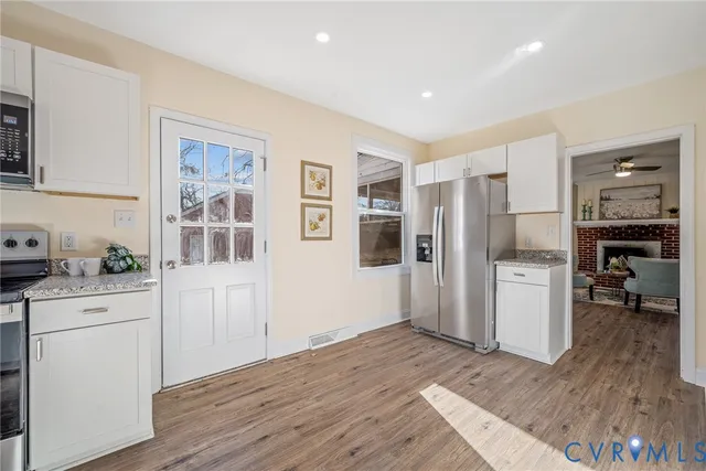 a kitchen with stainless steel appliances a refrigerator and a stove top oven