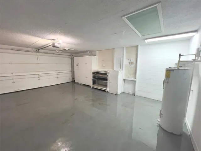 an empty room with a fireplace and cabinet