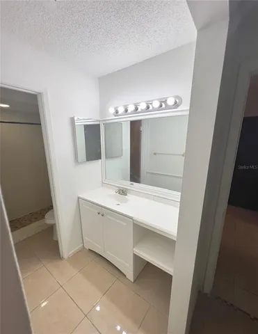 a bathroom with a double vanity sink and mirror