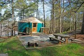 a view of backyard with a table and chairs under an umbrella