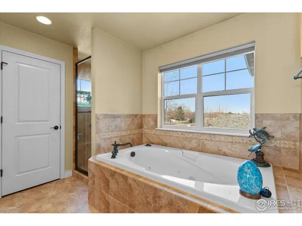 a bedroom with a bed a window and dresser