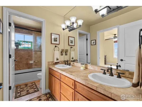 a bathroom with a double vanity sink a mirror and a