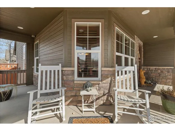 a balcony with table and chairs