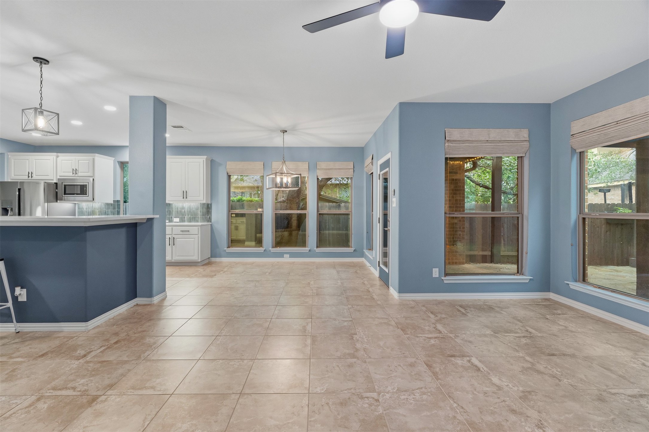 3935 Bowstring Bend Cedar Park, TX 78613 - Photo 19 of 39 A wall of windows brings in views of the backyard trees while keeping the space bright and inviting