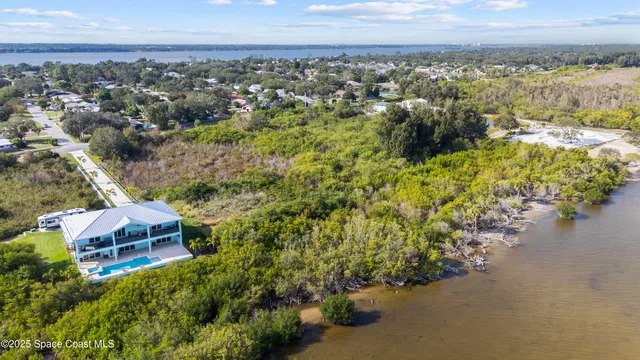 an aerial view of a house with a yard