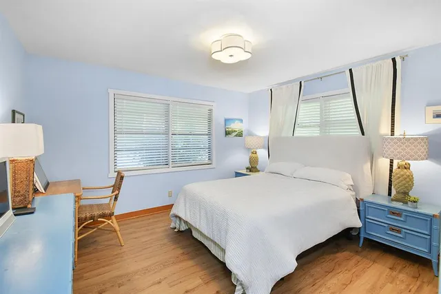 a large bed sitting in a bedroom next to a window