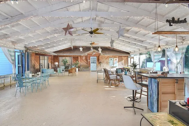 a view of a patio with dining table and chairs