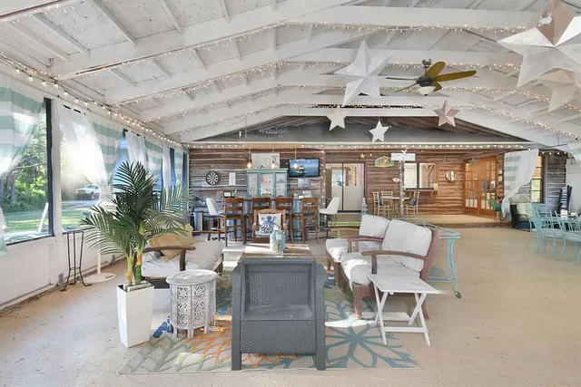 a living room with lots of furniture and a chandelier