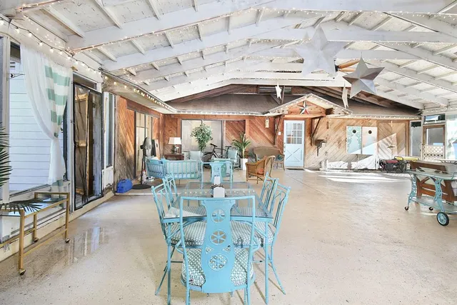 a view of a patio with dining table and chairs