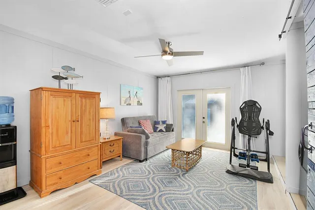 a living room with furniture and wooden floor