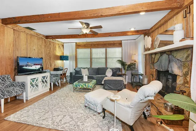 a living room with furniture a flat screen tv and a fireplace