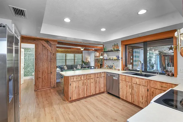 a large kitchen with stainless steel appliances granite countertop a stove and cabinets