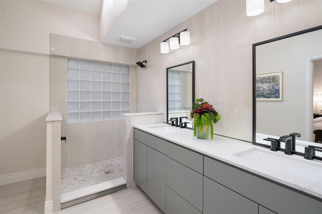 14604 Hemingway Court Addison, TX 75001 - Photo 13 of 27 a bathroom with a sink and a mirror