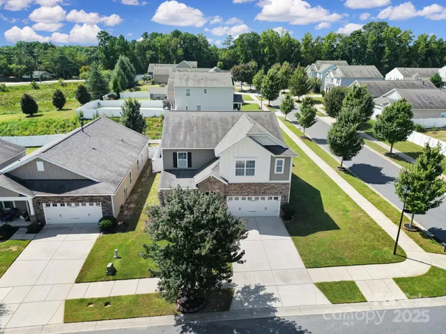 a aerial view of a house with a yard