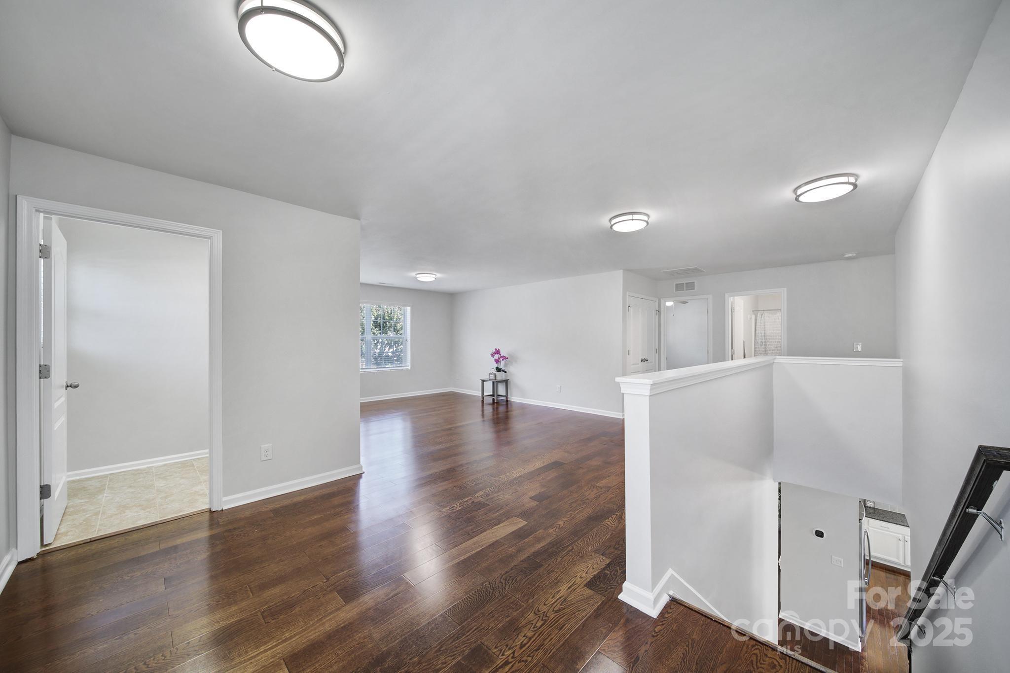1541 Spring Blossom Trail Fort Mill, SC 29708 - Photo 23 of 43 a view of empty room with wooden floor