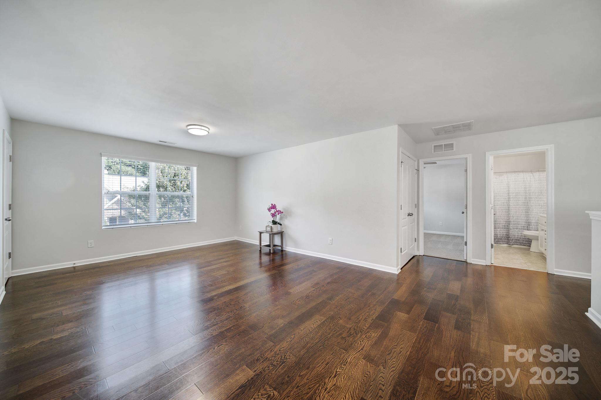 1541 Spring Blossom Trail Fort Mill, SC 29708 - Photo 25 of 43 an empty room with wooden floor and windows