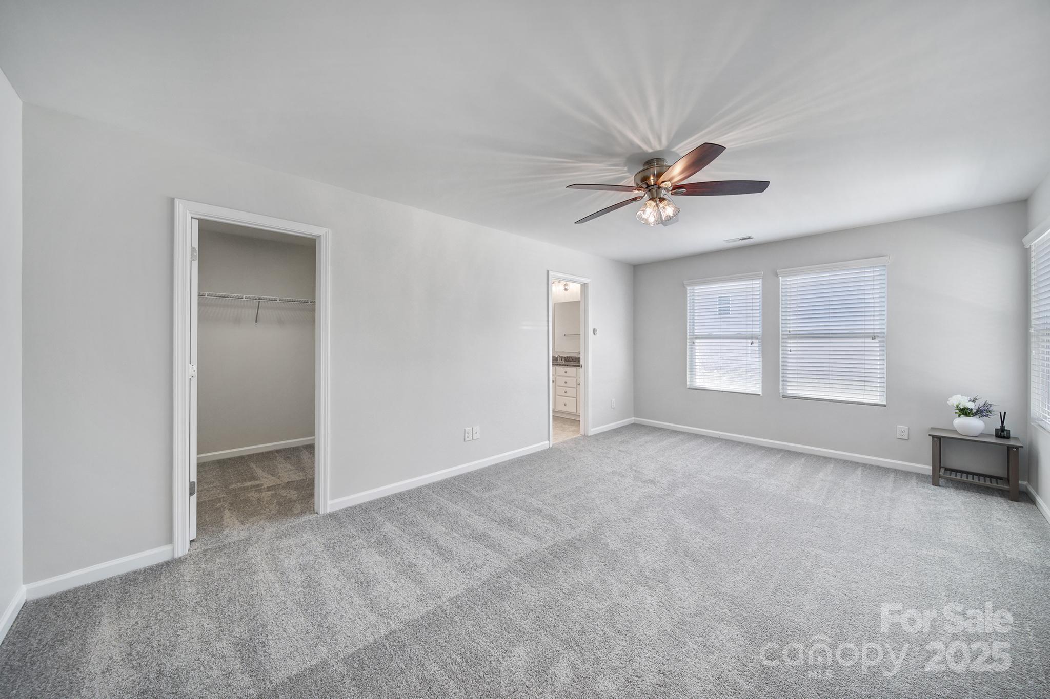 1541 Spring Blossom Trail Fort Mill, SC 29708 - Photo 32 of 43 an empty room with windows and a ceiling fan