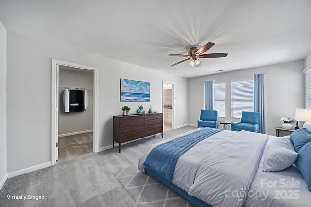 a bedroom with a bed and a ceiling fan