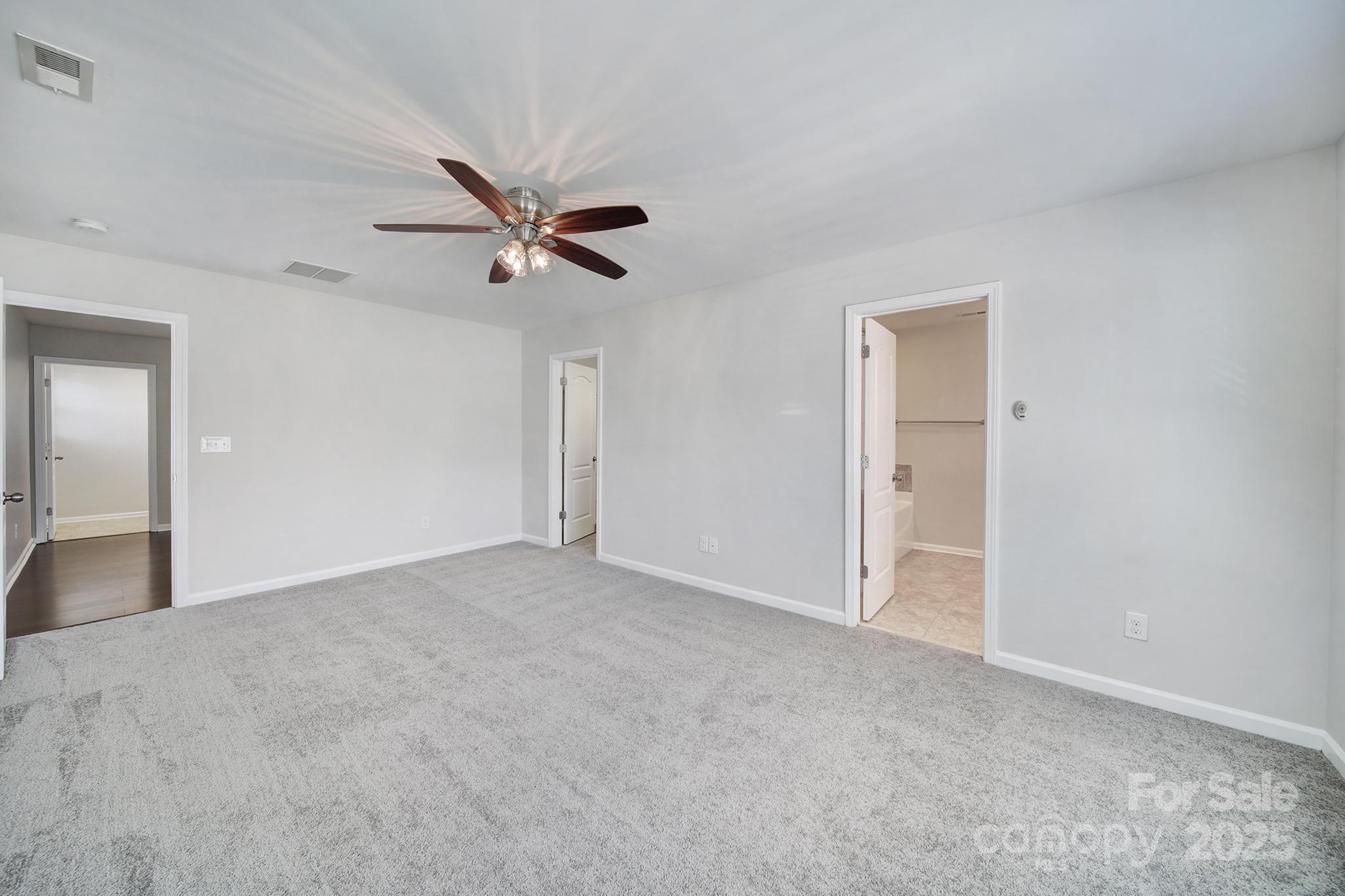 1541 Spring Blossom Trail Fort Mill, SC 29708 - Photo 35 of 43 an empty room with closet and a chandelier fan