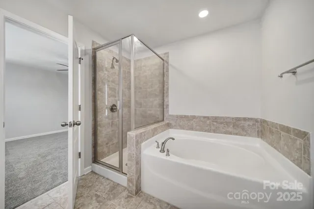 a bathroom with a bathtub and a shower