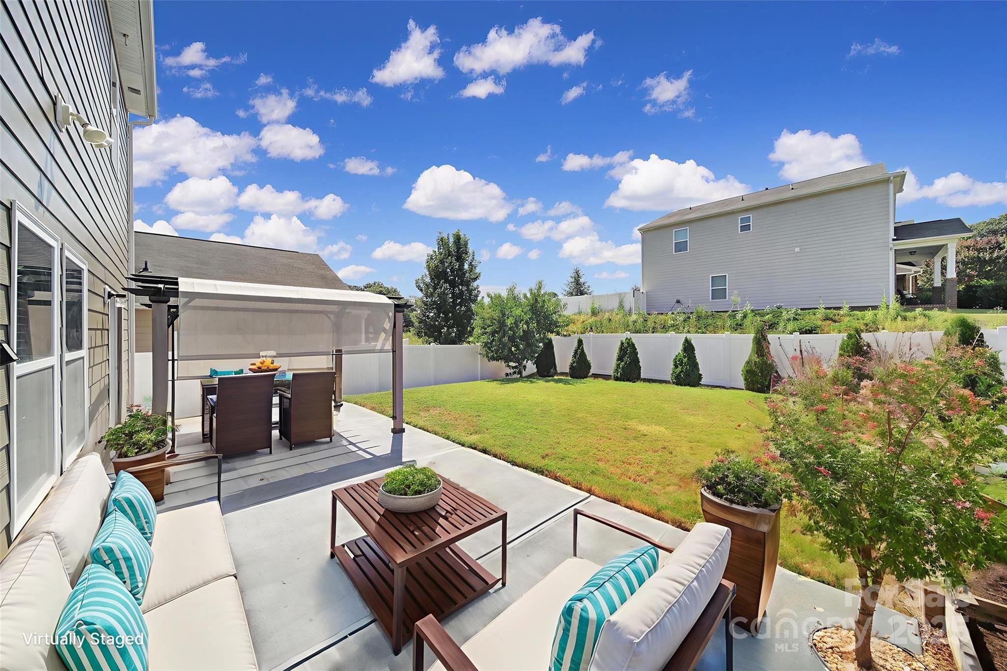 1541 Spring Blossom Trail Fort Mill, SC 29708 - Photo 39 of 43 a view of a patio with couches table and chairs with potted plants
