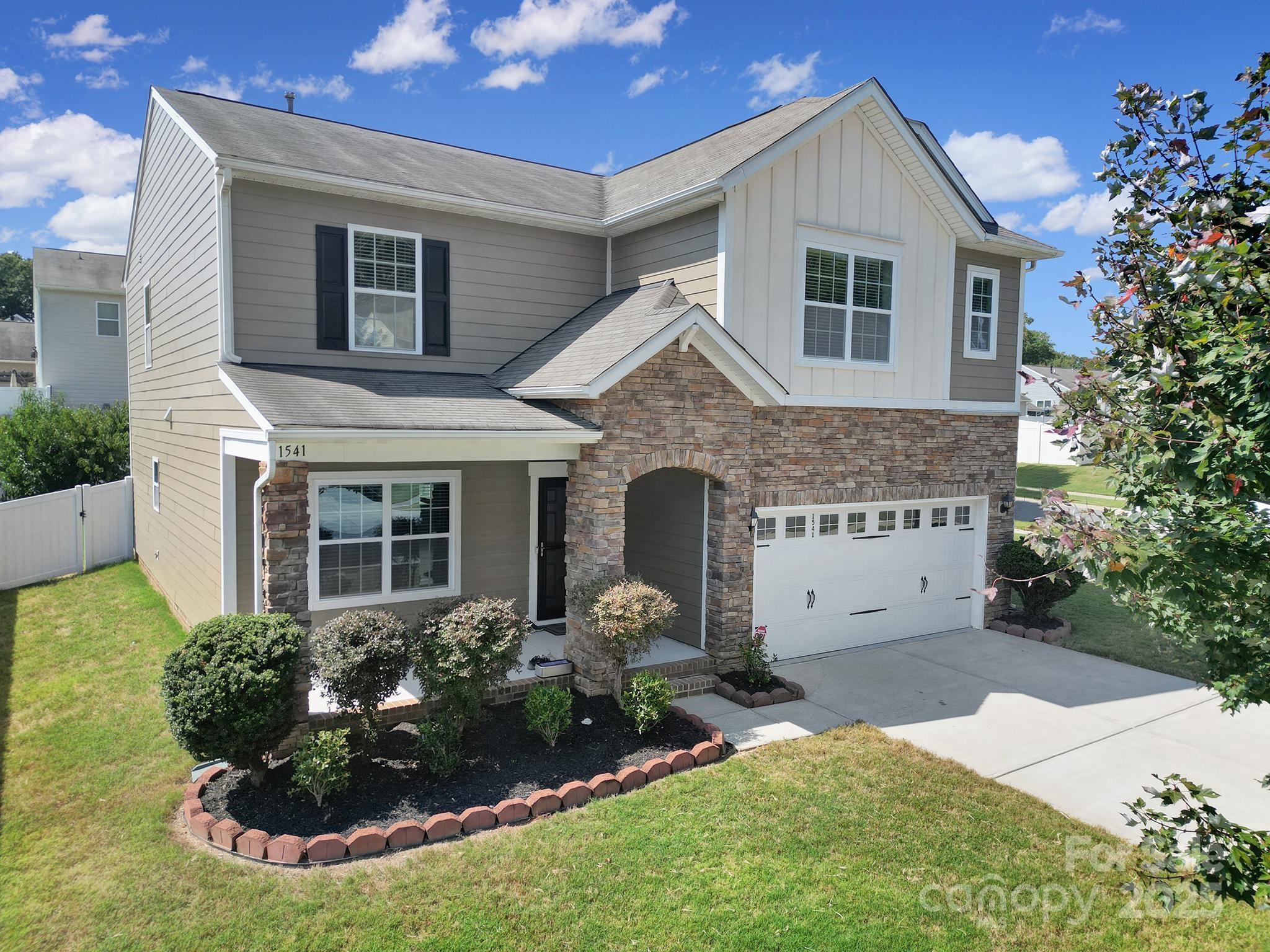 1541 Spring Blossom Trail Fort Mill, SC 29708 - Photo 4 of 43 a front view of a house with a yard and garage