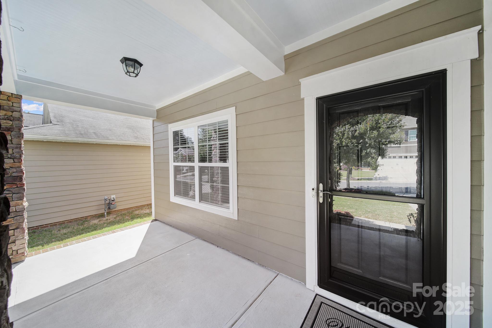 1541 Spring Blossom Trail Fort Mill, SC 29708 - Photo 5 of 43 a view of an empty room with a window and wooden floor